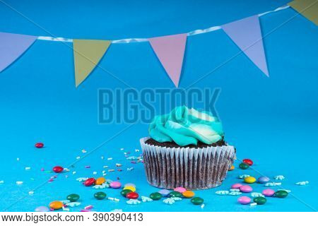 Chocolate Cupcake Decorated With Sugar Snowflakes, Colorful Candies