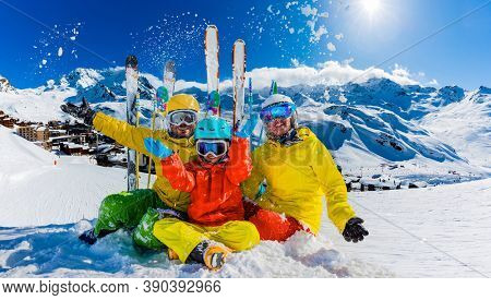 Happy family enjoying winter vacations in mountains, Val Thorens, 3 Valleys, France. Playing with snow and sun in high mountains. Winter holidays.