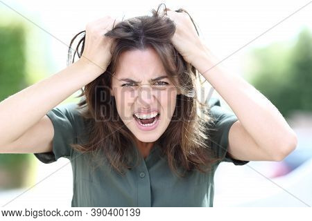 Front View Portrait Of An Angry Woman Shouting Looking At Camera In The Street