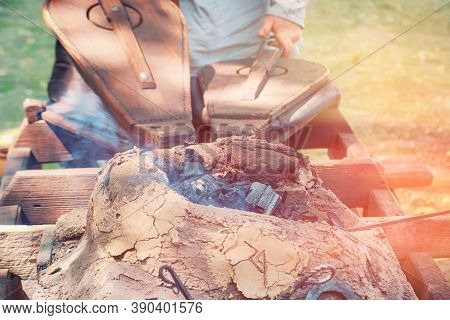 The Forge In The Open Air For Wrought Iron. The Bellows Of The Blacksmith And The Blacksmith Blowing
