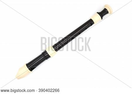 Black Flute Recorder On A White Isolated Background, Top View, Textured