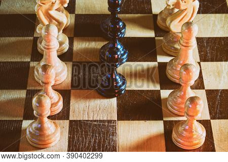 Black Chess Pawns Surrounded By White Pieces On A Chessboard, Textured