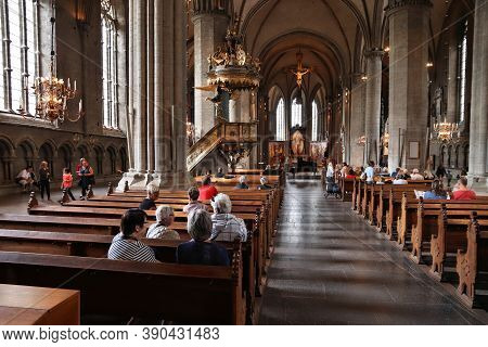 Linkoping, Sweden - August 25, 2018: People Visit The Romanesque Cathedral In Linkoping, Sweden. The