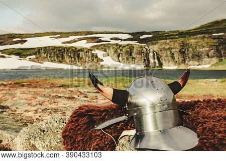 Viking Helmet On Lake Shore In Norway. Tourism And Traveling Concept