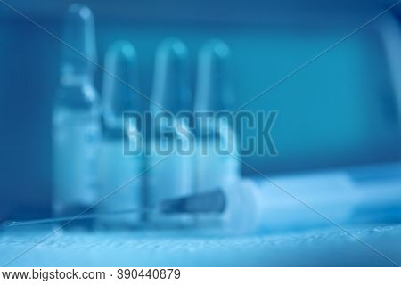 Blurry Medical Blue Background. Syringe And Medicine. Syringe And Ampoules Medical Concept.