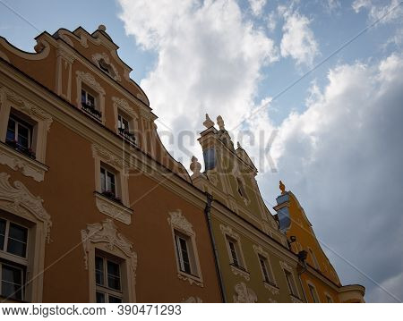 Part Of The Facade Of House In German Style Painted In Beige Against Light Sky