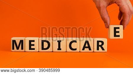 Wooden Cubes With Word 'medicare'. Male Hand. Beautiful Orange Background. Medical Concept. Copy Spa