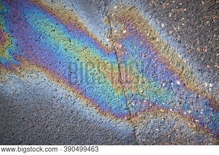 Gas Stain On Wet Asphalt Caused By A Leak Under A Car Or Truck