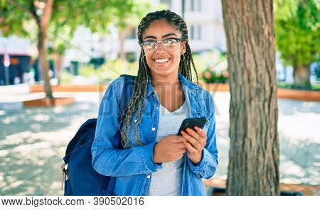 Young african american student woman smiling happy using smartphone at the university campus