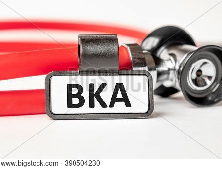 Bka Below The Knee Amputation. Lettering On A Business Card With A Holder, Next To The Red Stethosco