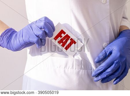 Fat Word On Paper In Pocket Of Doctor Close Up, Female In Protecive Gloves