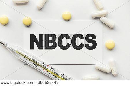 On White Business Card The Inscription Nbccs Nevoid Basal Cell Carcinoma Syndrome. Near Tablets And 