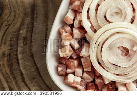 Italian Pancetta, Bacon Cubes, Diced Ham, Cutted Pork, Sliced Onion In Square White Plate On Wooden 