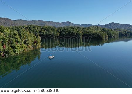 Aerial View Of Pontoon Boat On Lake Santeetlah, North Carolina In Autumn.