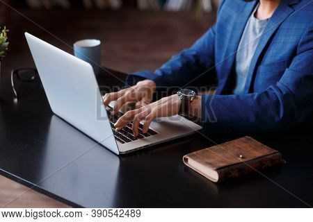 Businessman Using Laptop Computer At Home. Close Up Of Male Hands Typing On Laptop Keyboard In Offic