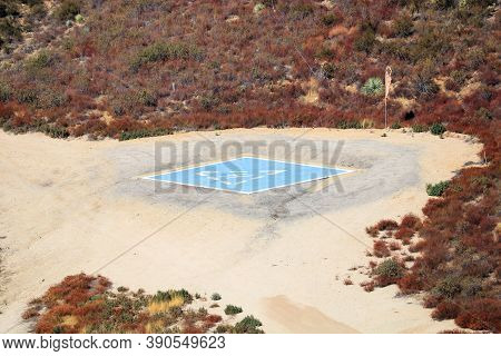 Heliport Where Helicopters Land And Take Off Besides A Navigational Aviation Windsock Surrounded By 
