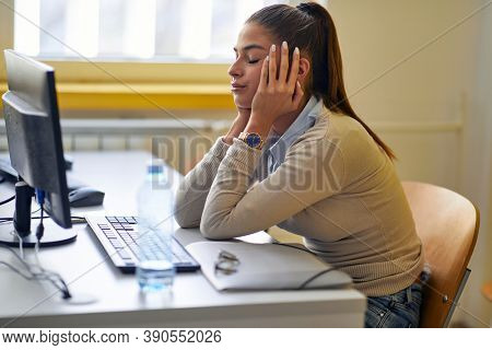 A female student indisposed about difficult lesson in the university classroom. Smart young people study at the college. Education, college, university, learning and people concept