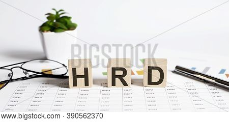 Text Of Hrd On The Wooden Cubes On Chart With Pen And Glasses