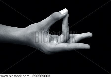 Shot Of A Male Hand Demonstrating Aakash Mudra Isolated On Black Background.