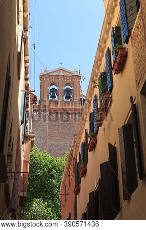 Narrow Street With View To A Belltower Of Chirch. Venice. Italia.