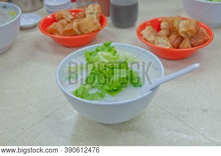 Fresh Plain Congee Rice Porrridge Topping With Green Shallot And Chinese Donut In Hong Kong