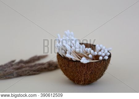 Cotton Ear Swabs With Wooden Base In A Coconut Cup. Zero Waste Concept