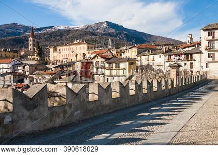 Scenic View Of Dronero Town With Snow On The Mountains In Cuneo Province, Piedmont, Italy From Ponte