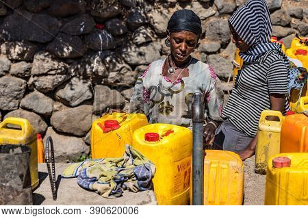 Lalibela, Ethiopia - Feb 14, 2020: People Getting Water At A Water Point In Lalibela, Ethiopia. Afri