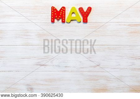 Wooden Letters Written May Month On Vintage Background. Inscription May With Copy Space. Top View. M