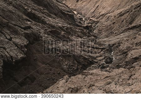 Dark Aged Shabby Landslip Surface Divided By Huge Cracks And Layers. Coarse Brown Mud And Clay Or Ro