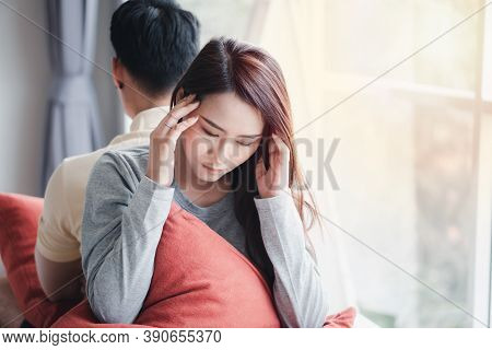 Unhappy Couple Sitting Behind Each Other On The Couch And Avoid Talking Or Looking At Each Other, Ca