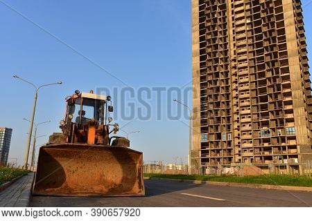 Wheel Loader With A Bucket On A Street In The City During The Construction Of The Road. Construction