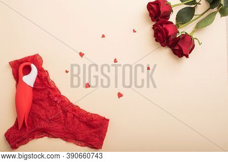 Flat Lay. Womens Red Lace Panties Clitoral Vibrator In The Shape Of A Tulip And Scarlet Roses. The B