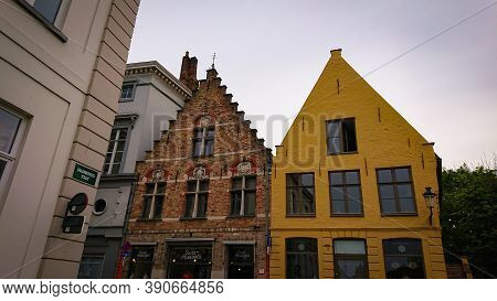 Bruges, Belgium - May 12, 2018:  Roofs And Windows Of Old Authentic Brick Houses On Street Sint-jako