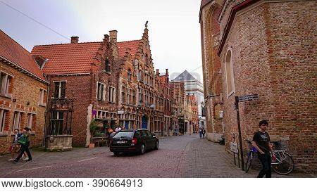 Bruges, Belgium - May 12, 2018:  Roofs And Windows Of Old Authentic Brick Houses On Street Sint-jako