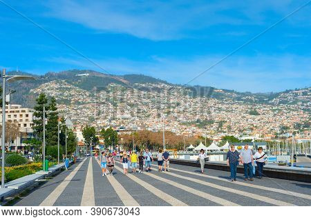 Funchal, Madeira Island, Portugal - Feb 04, 2020: Group Of People Walking By Embankment Of  Funchal.