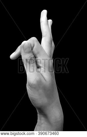 Side View Of A Male Hand Demonstrating Vayu Mudra Isolated On Black Background.