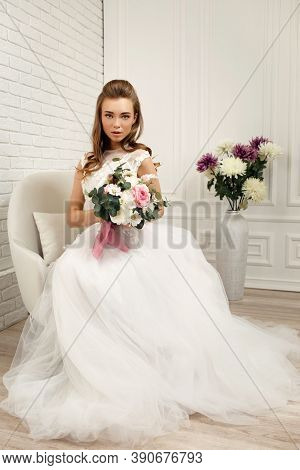 Gorgeous Beautiful Young Bride With Flower Bouquet In White Studio Interior, Full Lenth