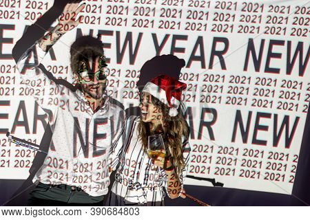 Beautiful Young Couple In Love Having Fun At New Year's Eve Party, Singing And Dancing At Midninght 