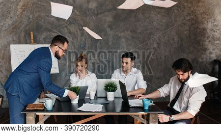 Angry Boss Reprimanding Employee For Bad Work Result Sitting At Conference Table, Male Ceo Scolding 