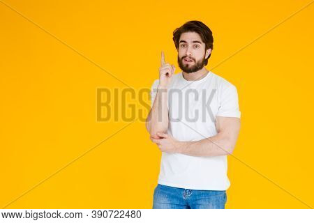 Young Handsome Man With Beardwhite Shirt Standing Over Yellow Background Pointing Finger Up With Suc