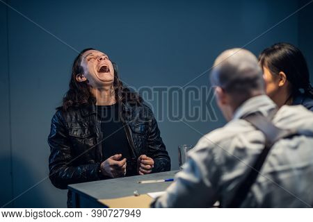 Young Police Officers Are Interrogating, The Suspect Laughs Audaciously.