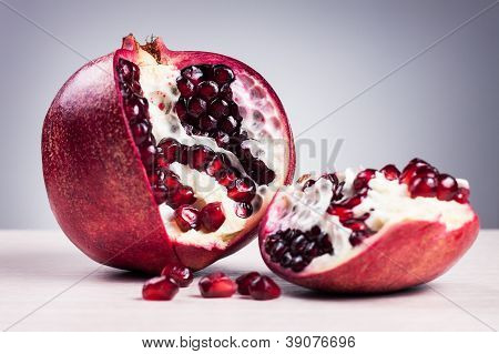 Granatum On Table Over Grey Background