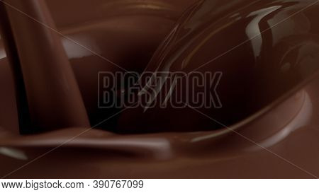 Detail of pouring hot chcocolate with splash. Studio macro shot.