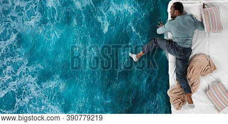 Portrait Of A Young African Man Sleeping In Comfortable Bed And Dreaming About Ocean Or Sea. Top Vie