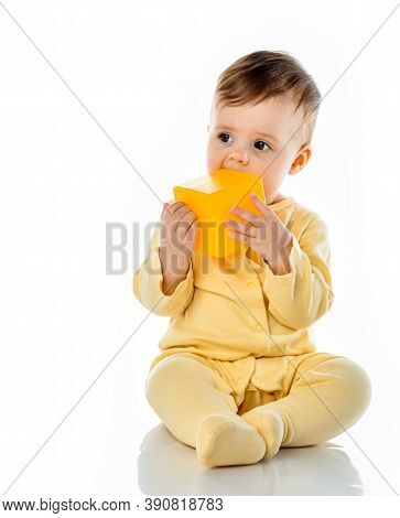 Little Cute Baby Child Gnawing Toy Chewing Yellow Block Cube Sitting On Floor. Ecological Hygienic H