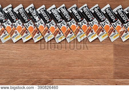 Many Nescafe Caramel Cream Coffee Sticks On Wooden Background. Nescafe Is A Brand Of Coffee Made By 