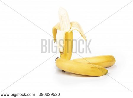 Shooting In The Studio. A Branch Of Ripe Yellow Bananas In A Peel. On White Background. Close-up