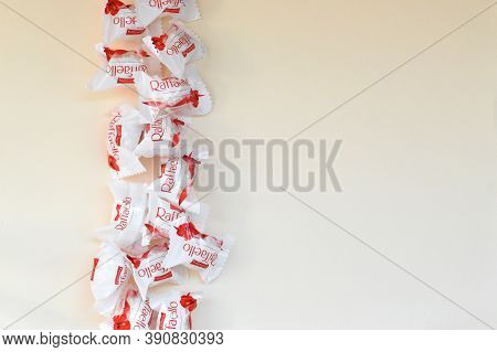 Raffaello Candies On Beige Background. Raffaello Is A Spherical Coconut Almond Confection That Itali