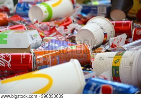 Many Wrappings And Cans From Used Products By Famous Worldwide Brands. Pattern Of Trash Of Various C